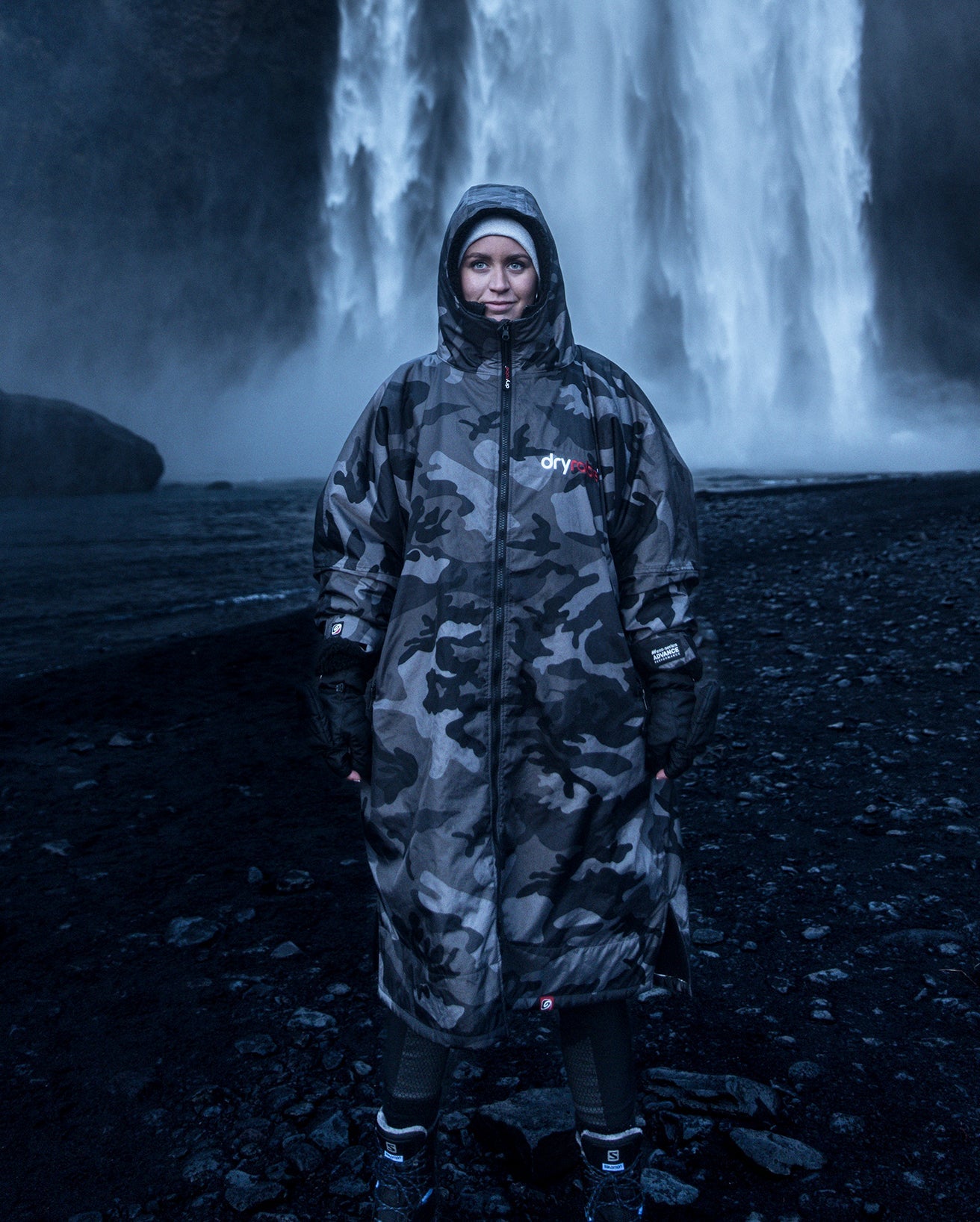 Woman stood in front of waterfall, wearing  Black Camo dryrobe® Advance Long Sleeve