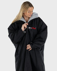 Woman wearing Black Grey dryrobe® Advance zipped up
