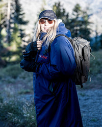 1|Woman carrying backpack and camera, wearing  Navy Grey dryrobe® Advance Long Sleeve