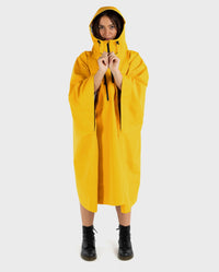 Woman wearing Yellow dryrobe® Waterproof Poncho  wiht hood up 