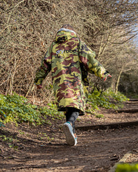 1|Girl walking up a path wearing Camo Grey dryrobe® Advance Kids Long Sleeve