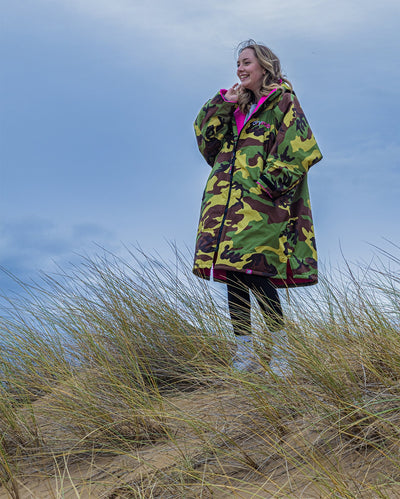 1|Girl stood on top of sand dune, wearing Camo Pink dryrobe® Advance Kids Long Sleeve