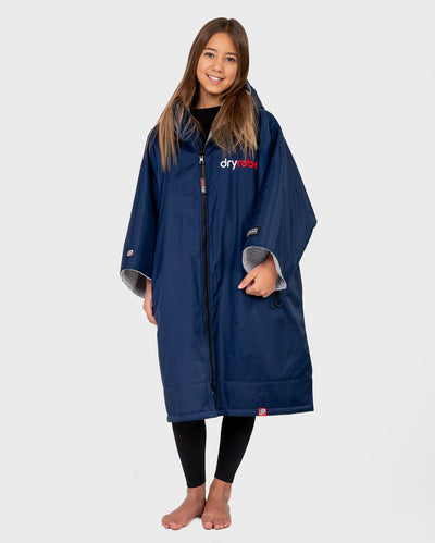 Girl smiling wearing Kids dryrobe Advance Short Sleeve change poncho in Navy Grey 