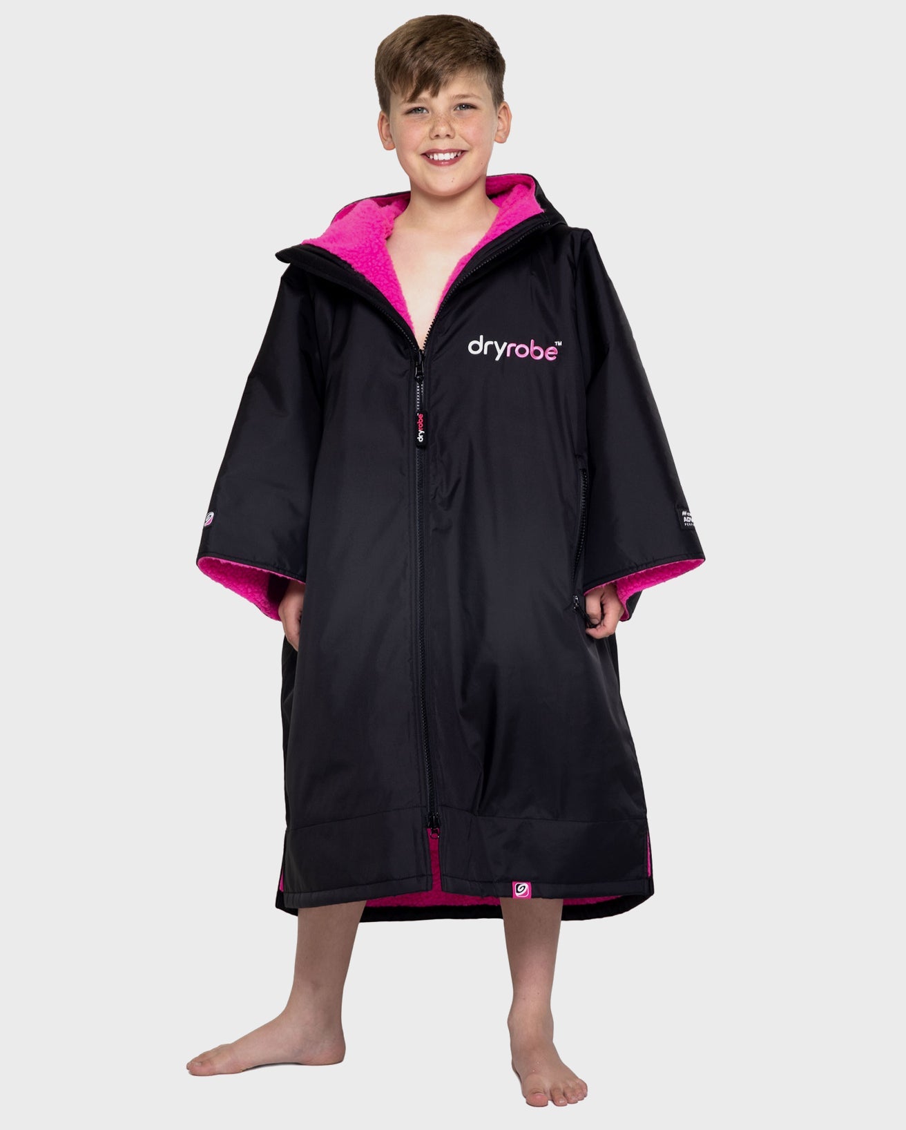 Boy wearing Black Pink dryrobe® Advance Kids Short Sleeve change poncho