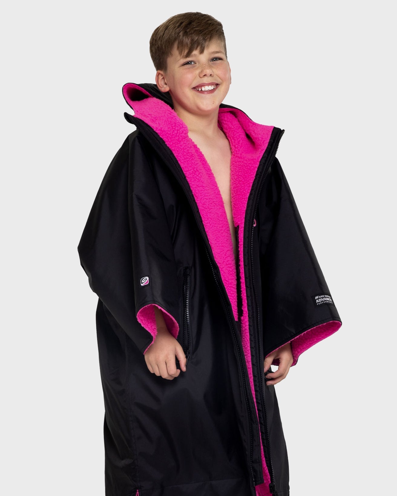 Boy wearing Black Pink dryrobe® Advance Kids Short Sleeve change poncho unzipped