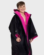 Boy wearing Black Pink dryrobe® Advance Kids Short Sleeve change poncho unzipped